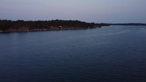 Blue-hour-hues-over-Stockholm-Archipelago,-calm-water-and-distant-shoreline