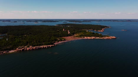 Drone-shot-approaching-the-Jussaro-island,-sunny-day-in-Uusimaa,-Finland