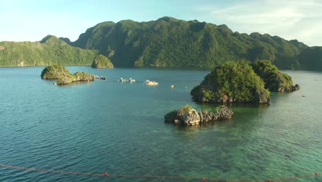 Aerial-view-of-Siete-Pecados-coral-reef-islands-and-mountains-near-Coron,-Palawan