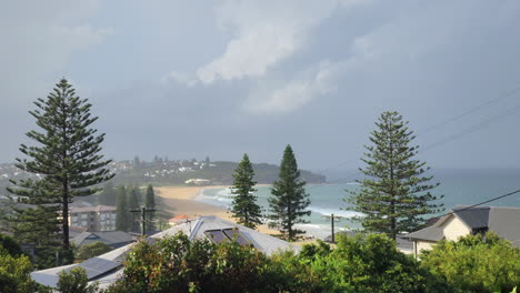 Panoramic-view-of-Curl-Curl-beach-in-Sydney,-Australia,-on-a-cloudy-morning