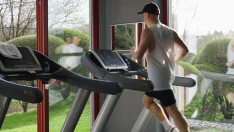 Male-do-intensive-cardio-training-session-on-treadmill,-indoor-fitness