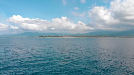 Drone-Aéreo-Bajo-Vuela-Rápido-Sobre-El-Mar-Azul-Claro-Tropical-En-La-Pequeña-Isla-Asiática-De-Bali-En-Un-Día-Soleado