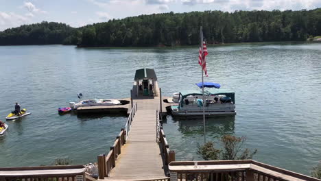 timelapse-at-the-lake-james-fuel-station-with-boat-USA-flag-and-two-men-in-a-jetski