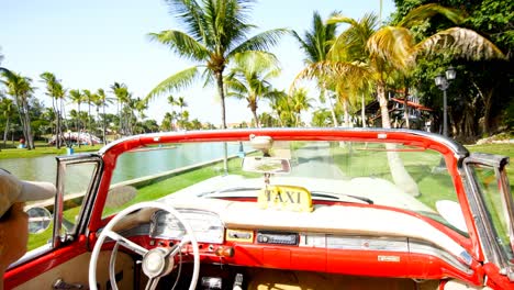 Shooting-video-from-inside-the-car-to-the-park-with-lake-of-Varadero,-Cuba-during-the-day