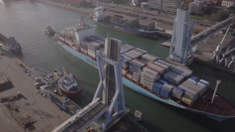 Aerial-footage-of-a-Maersk-Ultra-large-container-vessel-loaded-with-various-container-brands,-at-sea-in-Porto,-Leixões,-Northern-Portugal