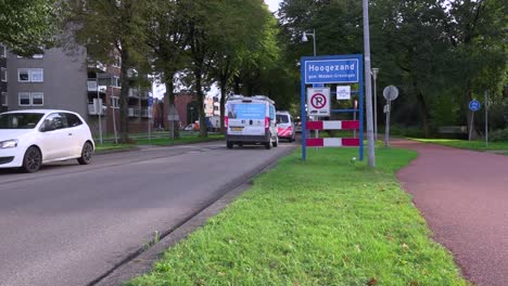 Cars-and-police-van-entering-Hoogezand-in-Midden-Gronigen,-the-Netherlands