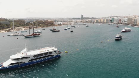4k-aerial-drone-footage-of-a-ship-and-boat-filled-harbor-of-the-Mediterranean-tourist-resort-town-of-Sliema,-Malta