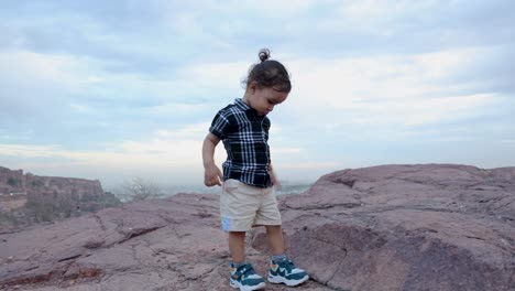 isolate-infant-walking-at-mountain-rock-at-evening