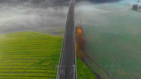 flight-over-a-misty-railroad-bridge-in-the-morning
