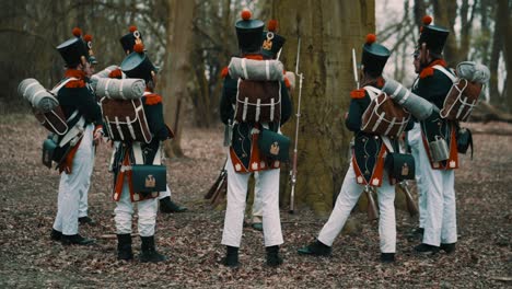 Group-of-enigmatic-soldiers-on-teambuilding-coming-together-with-little-steps-in-a-beautiful-forest