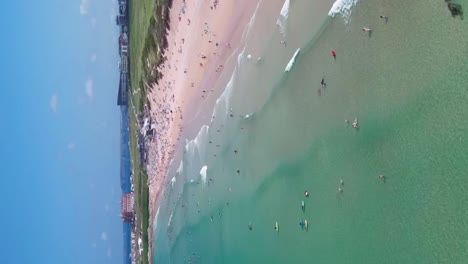 Fistral-Beach-with-Clear-Turquoise-Waters-with-People-Enjoying-the-Summer-Sun
