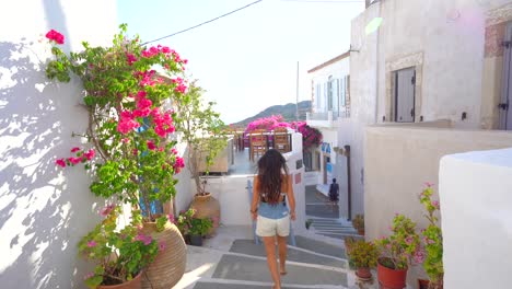 Unrecognizable-young-brunette-woman-walking-through-streets-of-Chora,-Greece