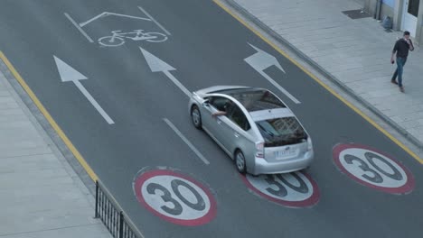 High-angle,-cars-driving-on-road-with-30kmph-speed-limit-signs-in-Spain