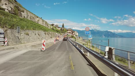 Driving-on-a-lakeside-road-near-Lavaux-vineyards-from-Lausanne-to-Montreux,-clear-day