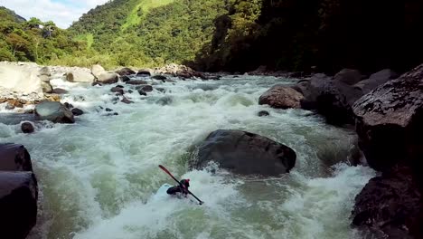 Kayaker-Rowing-through-Rapids-in-Amazonia-River-to-be-Flipped-over-after-going-over-Stone