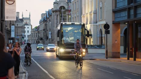 Un-Autobús-Moderno-Recorre-Una-Hermosa-Calle-Concurrida,-Crepúsculo