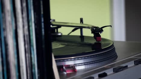 Old-black-vinyl-spinning-on-the-old-turntable-with-stylus-reading-the-record