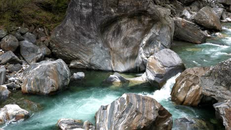 Verzasca-valley-with-deep-boulder-stones-weathered-and-polished-round-from-green-water