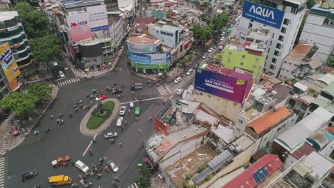 Tilt-Down-Aerial-of-busy-city-roundabout-Ho-Chi-Minh-Saigon