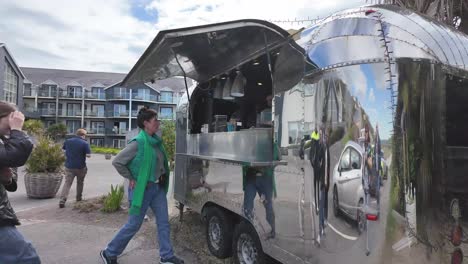 Coffee-truck-in-the-car-park-of-Inchidoney-lodge-and-spa,-with-people-queuing-for-a-morning-coffee