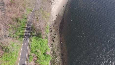 Aerial-view-of-two-rollerskaters-on-the-riverside-road-at-Providence-Rhode-Island