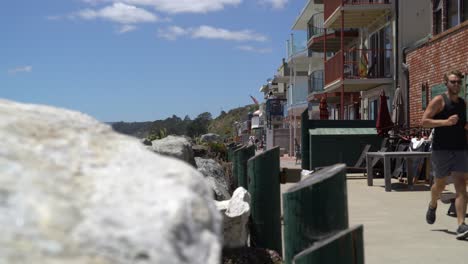 Runner-jogging-in-front-of-beachhouses