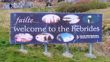 View-of-the-Welcome-to-the-Outer-Hebrides-sign-at-the-ferry-terminal-on-the-remote-and-wild-Isle-of-Barra-in-the-Scottish-Highlands,-Scotland-UK