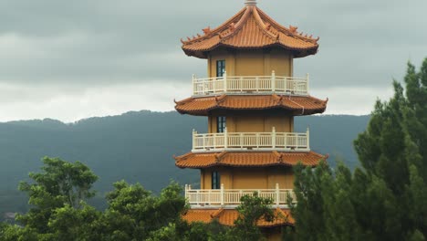 Buddist-Temple-Tower-with-mountains-in-background-on-overcast-day