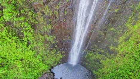 aerial-footage-of-Mao-a-Falls-on-the-island-of-Oahu-Hawaii-the-footage-descends-on-the-falls-toward-the-plunge-pool-with-tropical-rainforest-surrounding-the-island-falls