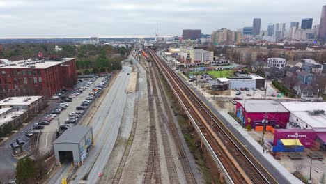 Aerial-of-King-Memorial-subway-station-rail-track,-Husley-shipping-Yard-Beltline-stretch-and-Atlanta-Intown-neighborhood
