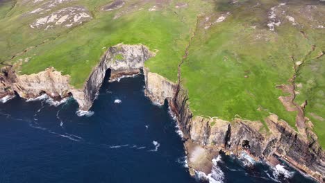 Aerial-View-of-Yesnaby-Vista-Point,-Scenic-Coast-of-Orkney-Scotland-UK-on-Sunny-Day,-Steep-Cliffs-and-Green-Landscape,-Drone-Shot-60fps