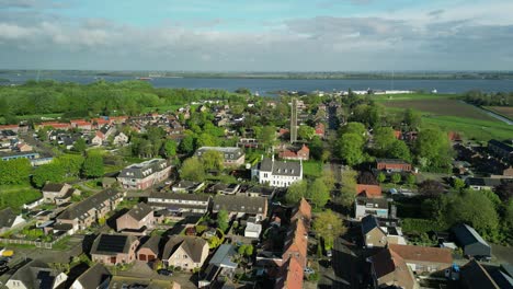 Aerial-footage-of-the-village-of-Moerdijk-in-the-Netherlands-with-a-tall-bell-tower-of-a-Roman-Catholic-church-in-the-center