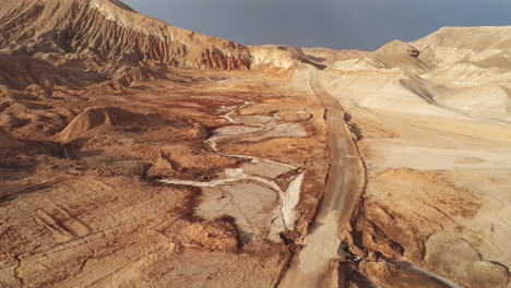 Aerial-View-of-Dry-Lifeless-Atacama-Desert-Landscape-And-Dusty-Valley-Road