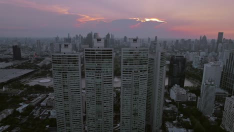 Aerial-drone-shot-over-Bangkok-city-skyline-in-Thailand-on-a-cloudy-evening