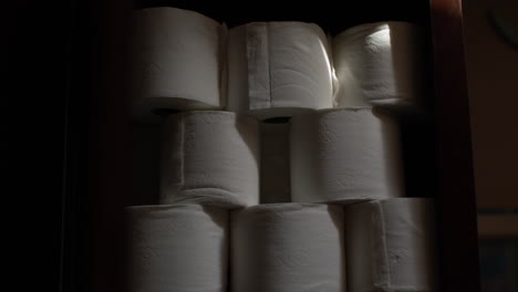 Stabilized-slow-zoom-out-shot-of-a-stack-of-toilet-paper-in-a-cupboard