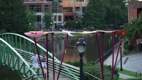 Shot-overlooking-a-bridge-and-river-in-Greenville,-SC