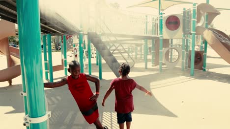 Two-kids-playing-in-water-mist-