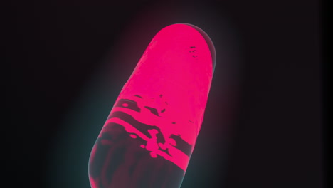 4k-3d-high-quality-motion-graphic-animation-of-a-bright-pink-liquid-splashing-around-inside-of-a-medicine-capsule-on-a-black-background