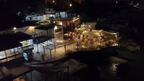 Few-People-Dine-In-At-Seafood-Restaurant-Enjoying-Their-Dinner-In-Anfeh,-Lebanon