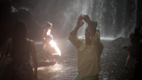 Young-couple,-tourist-capturing-beauty-all-around,-waterfall-location