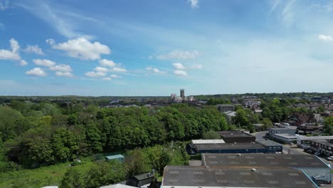 Slow-drone-shot-heading-towards-trees-with-the-Canterbury-Cathedral-on-the-horizon