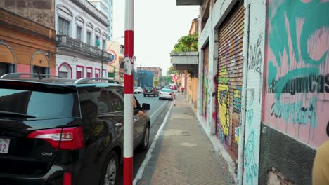 Walk-by-the-colorful-street-of-asuncion,-near-abandoned-buildings-painted-with-urban-graffiti