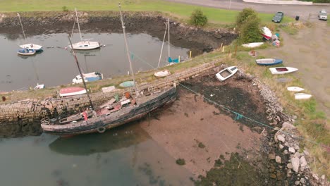 Flying-over-old-broken-ship-in-Charlestown-marina