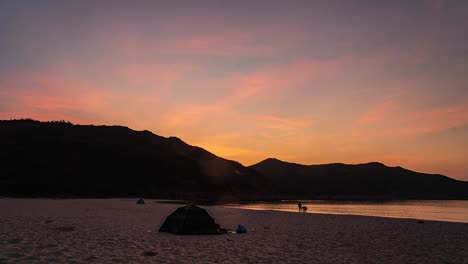 People-in-Sandy-beach-tent-Sai-Kung-Hong-Kong-island-watching-glorious-colourful-sunrise-clouds-timelapse