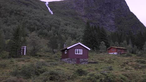 Small-cabin-at-the-side-of-the-road-in-mountain-terrain,-Norway,-Europe