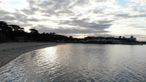 Drone-flight-over-the-beach-and-yacht-club-of-Mornington-Pier,-Melbourne-Australia