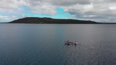Two-Fisherman-Paddling-in-Traditional-Boat-By-Coast-of-Vanuatu-Island,-Oceania,-Drone-Aerial-View