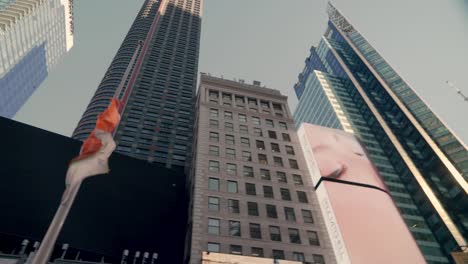 Extreme-low-angle-view-of-countless-flashing-digital-billboards-in-Times-Square,-New-York-City,-in-the-late-afternoon