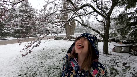 Pretty-Girl-Enjoying-The-Snowfall-At-The-Park-During-Winter-Season-In-Flat-Rock,-Michigan,-USA---Slow-Motion