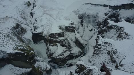 Iceland's-Rocky-Formation-of-Snow-and-Ice-from-an-Aerial-Drone-Tilting-Down-Overhead